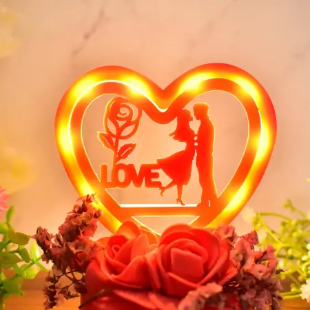 Romantic Heart-Shaped Love Couple Decorative Showpiece with Rose Base LED Light – Tabletop Gift for Home Decor, Anniversary, Valentine’s Day & Special Occasions (Battery Not Included) – 1 Pc